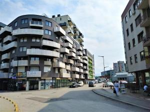 a building on the side of a city street at Orange Apartment in Sarajevo