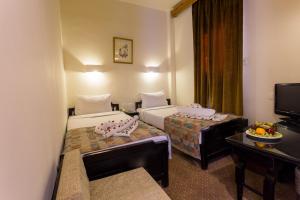 Postel nebo postele na pokoji v ubytování Hapi Hotel