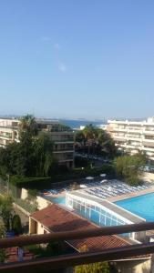 a view of the swimming pool at a resort at Heliotel Marine plages piscines tennis terrasse jardin in Saint-Laurent-du-Var
