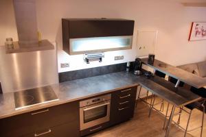 a kitchen with a stove and a counter top at Gîte Groseille in Ribeauvillé +7 photos