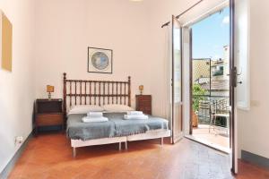 a bedroom with a bed and a sliding glass door at Via della Chiesa Apartments in Florence +13 photos