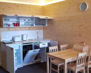 a kitchen with a table and a table and chairs at New Gudauri Suites in Gudauri