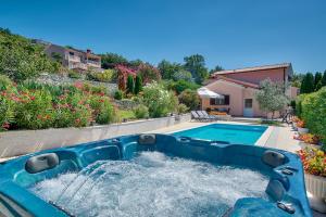 a pool with a water slide in a yard at Villa Ines in Labin