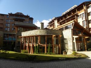 a building with a stone and wood at Saint Ivan Ski Apartments in Bansko