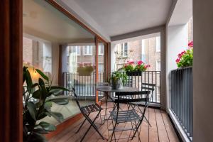 a balcony with a table and chairs and plants at Salt & Pepper Ghent in Ghent