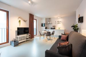 a living room with a couch and a table at Salt & Pepper Ghent in Ghent
