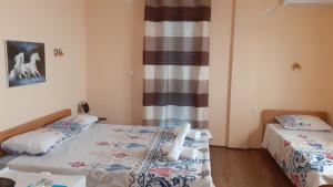 sypialnia z 2 łóżkami i oknem w obiekcie Sunshine w mieście Gewgelija