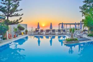 a swimming pool with a view of the ocean at Aphea Village in Kolymvari