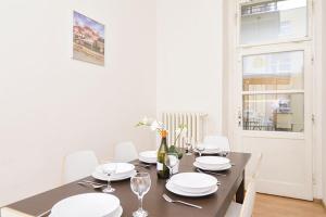 a dining room table with white plates and wine glasses at Apartments with 2 Bathrooms- 5 minutes from Old Town - 102 m2 in Prague