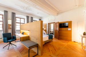 a bedroom with a bed and a desk and a chair at Schwan und Post Business Quarters in Bad Neustadt an der Saale