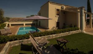 a backyard with a swimming pool and a house at Casa Rural en Cigarral de Villamarta Toledo con piscina y WIFI in Toledo