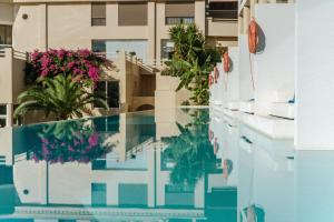 a view of the pool from the balcony of a building at Lindos Royal Resort in Líndos