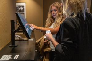 two women standing in front of a desk with a computer at Hotell Syfabriken in Falköping