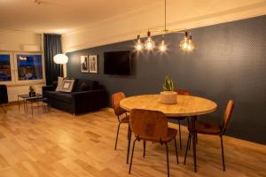 a living room with a table and a couch at Hotell Syfabriken in Falköping