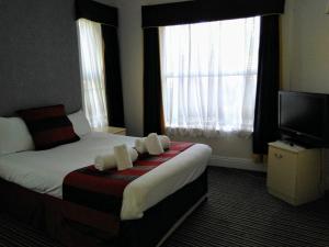 A bed or beds in a room at The Crown Hotel 