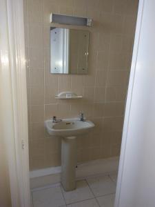 a bathroom with a sink and a mirror at The Crown Hotel in Stoke on Trent