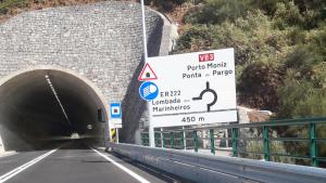a tunnel with signs on the side of a road at Madeira Native Motion Guest House in Fajã da Ovelha
