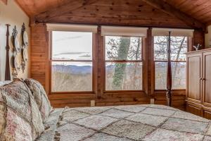 a bedroom with a bed and a large window at The Grey Moose in Blairsville