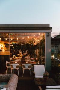 a restaurant with tables and chairs on a balcony at Boundary Shoreditch in London +17 photos