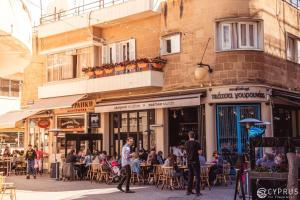 a group of people walking in front of a building at Maralia Hotel in Nicosia