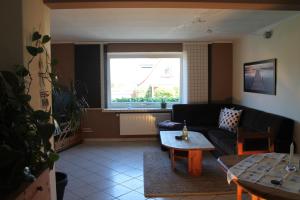 a living room with a couch and a table at Ferienwohnung Möwenblick in Flensburg