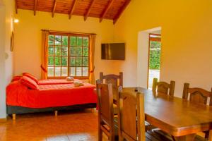 a bedroom with a bed and a dining room table at Complejo Vip Houses in Merlo