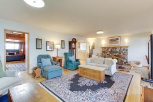 sala de estar con sillas azules y sofá en Lopez Island Agate Beach Waterfront Home en Islandale