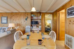 a dining room and living room with a table and chairs at Pelican's Perch in Florence