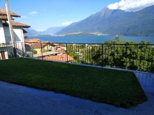 a balcony with a view of a lake and mountains at Apartment Rosa Dei Venti in Gravedona