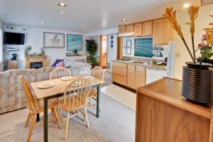 a kitchen and living room with a table and chairs at Flounder's Crib Condo in Lincoln City