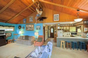 a living room with a couch and a kitchen at Darrs Beach Cottage in Neskowin