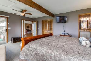 una camera con un grande letto e una TV a schermo piatto di Crystal Rose Cottage a Lincoln City