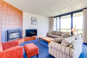 a living room with a couch and a fireplace at Sand & Sea: The Promenade (100) in Seaside