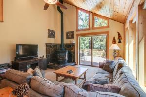 a living room with a couch and a fireplace at Tahoe Donner Greenbelt Retreat in Truckee