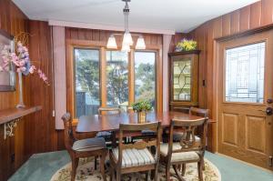 a dining room with a wooden table and chairs at Headland Cove Retreat in Mendocino