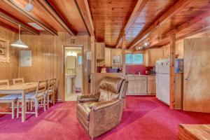 a kitchen and dining room with a table and a chair at 3Dogs Cabin in Government Camp