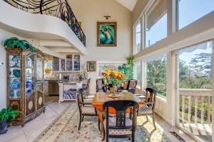 a dining room with a table and chairs and windows at Ocean Escape in Lincoln City