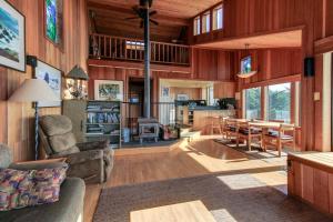 a living room with wooden walls and a dining room at Friederichs' Beach House in Manchester