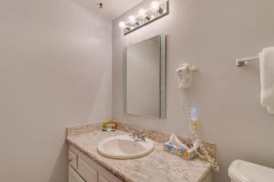 a bathroom with a sink and a mirror at Sand & Sea: The Breakers (200) in Seaside