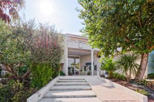 a walkway in front of a building with trees at Zenitude Hôtel-Résidences Toulon Six Fours in Six-Fours-les-Plages