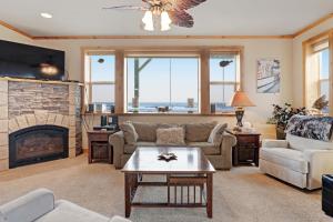 a living room with a couch and a fireplace at Sunset Beach House in Gold Beach
