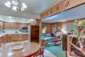 a kitchen and living room with a table and a couch at Tolovana Treasure in Cannon Beach