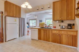 a kitchen with wooden cabinets and a white refrigerator at Spruce Landing in Gearhart