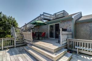 a house with a deck with a table and chairs at Mill View: La Maison de l'Artiste in Falmouth