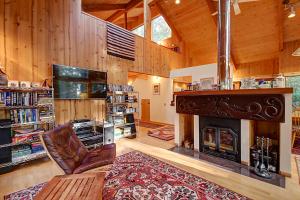 a living room with a fireplace and a tv at Longwell House in Sea Ranch