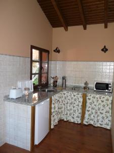 a kitchen with a sink and a counter top at Casa AL ABLUGO in Pola de Somiedo +1 photo
