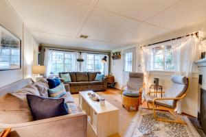 a living room with a couch and a table at Garden by the Sea in Seaside