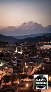 a city at night with mountains in the background at Kame House hostel in Huaraz