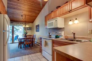 a kitchen with a sink and a table with chairs at Bay Point Lakefront 1B Up in Whitefish
