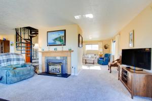 a living room with a television and a fireplace at Ocean View Terrace in Lincoln City